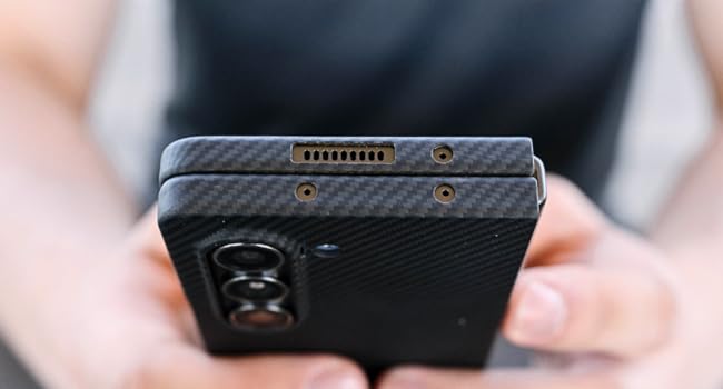 a man holding galaxy z fold 5 case in aramid fiber case