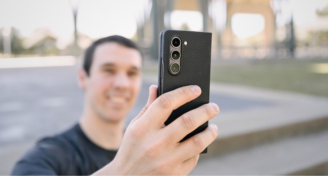 a man holding galaxy z fold 5 in aramid fiber case